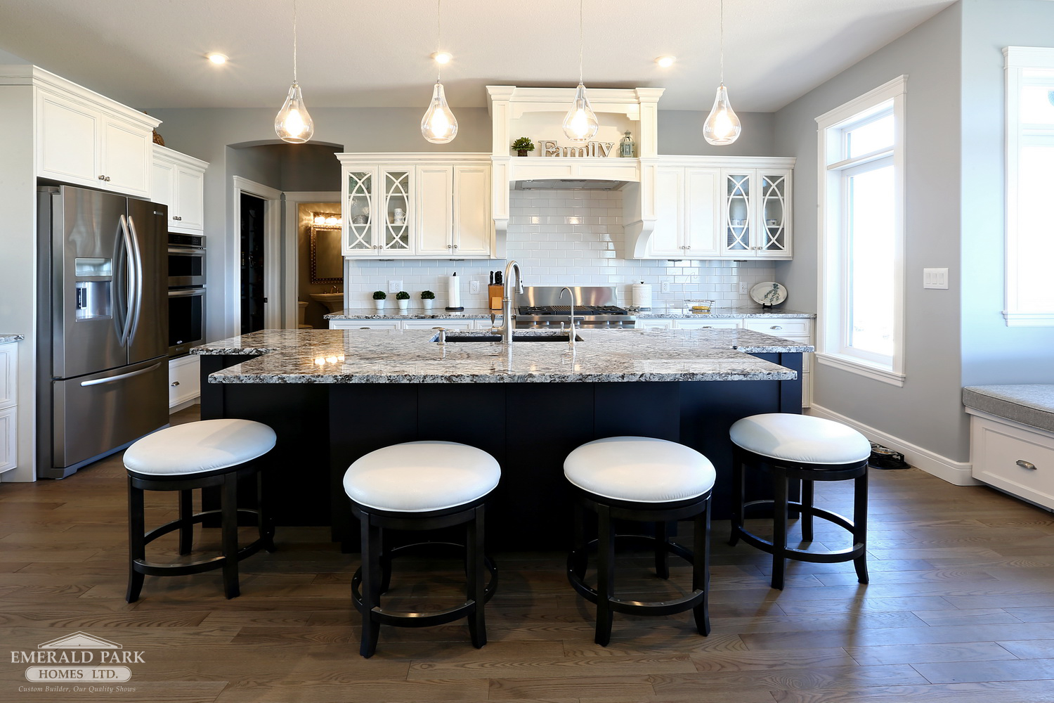 Emerald Park Homes Custom Designed New Holmes Approved Home Regina YQR large kitchen island with white bar stools white cabinets